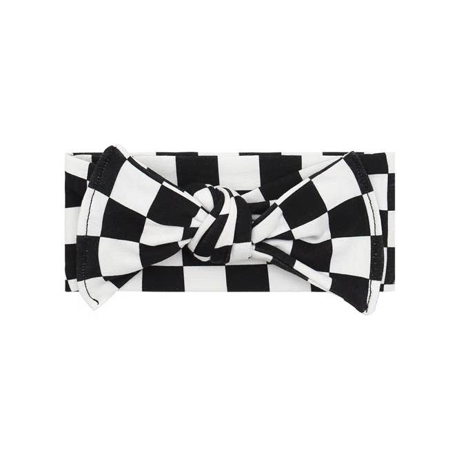 Soft cotton baby headband with a black and white checkerboard print and a stylish front knot detail.
