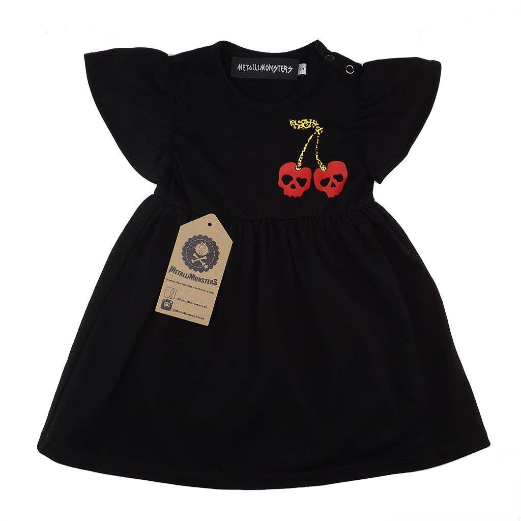 Black cotton girls' dress featuring red skull cherry print, flutter sleeves, and shoulder popper fastenings.