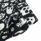 Black and white cotton shorts with a skull and bone print, featuring an elasticated waistband and side pocket.