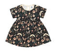 Short-sleeve cotton girls' dress in black with a whimsical butterfly, crescent moon, and floral print.